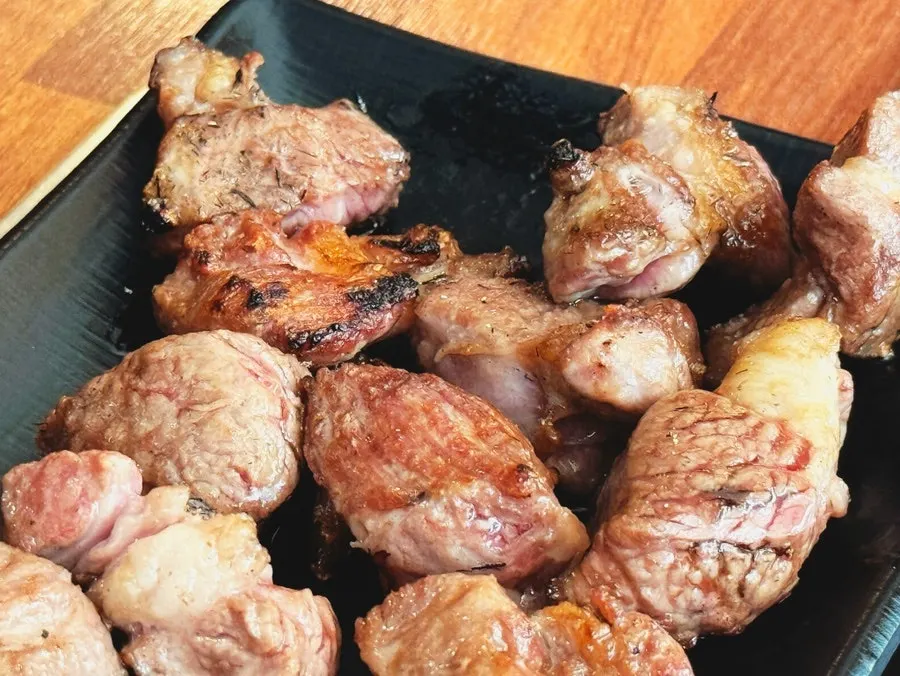 Lamb loin grilling over charcoal