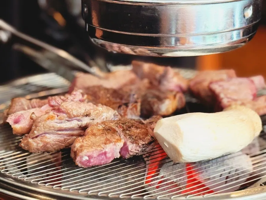 A piece of lamb rib dipped in salt and wasabi