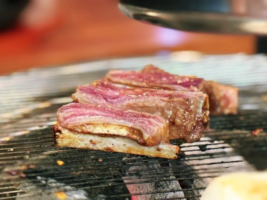 Seasoned rib fingers grilling with mushrooms