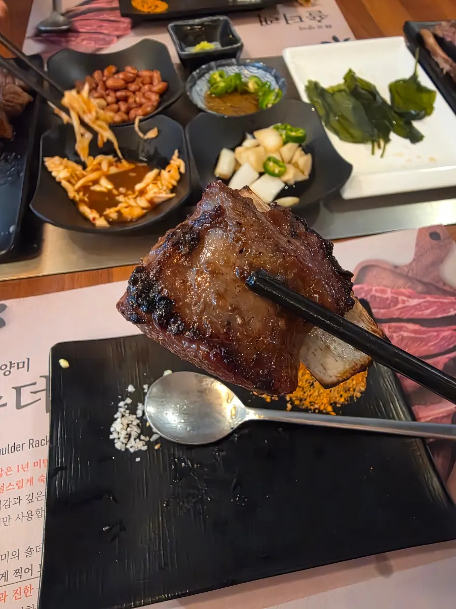 A soy-marinated lamb rib with meat sliding right off the bone