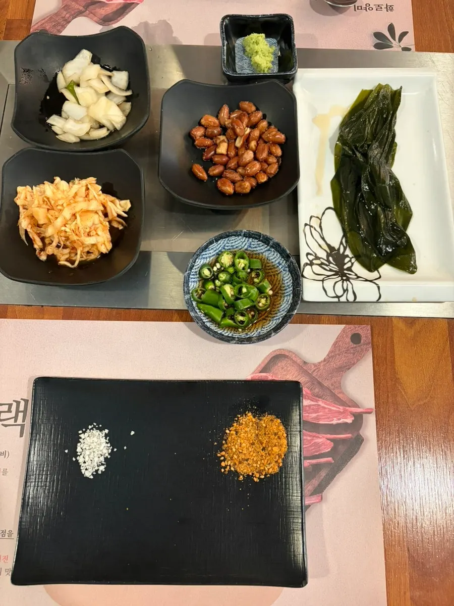 Side dish spread with cumin salt, wasabi, and other sauces
