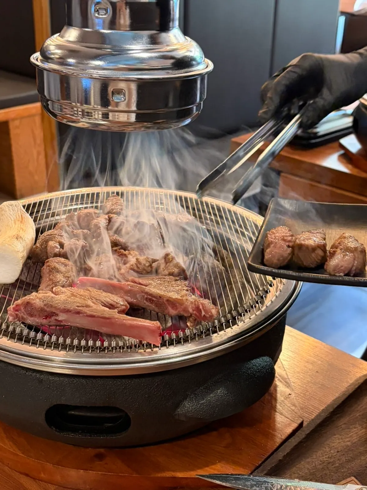 Lamb grilling on the charcoal brazier beside the table