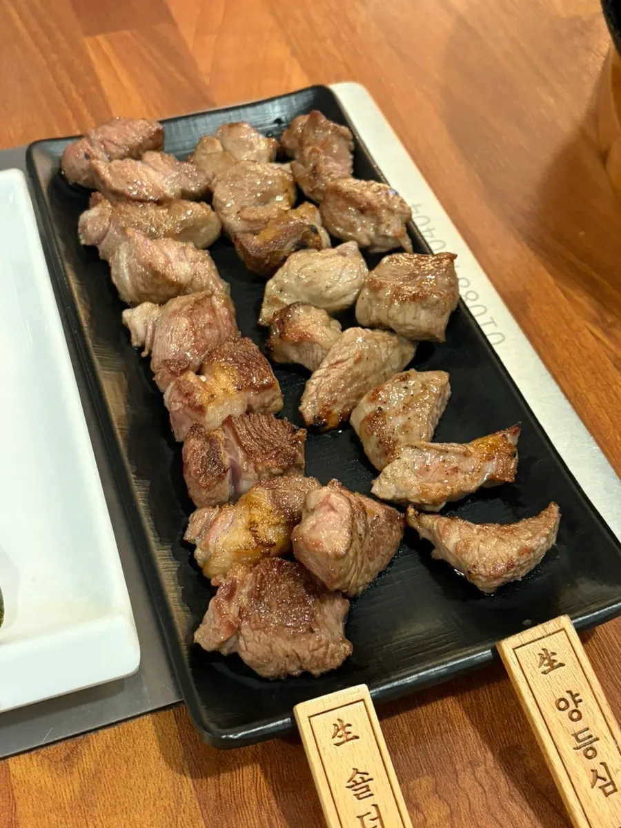Shoulder rack and lamb loin being grilled on the brazier
