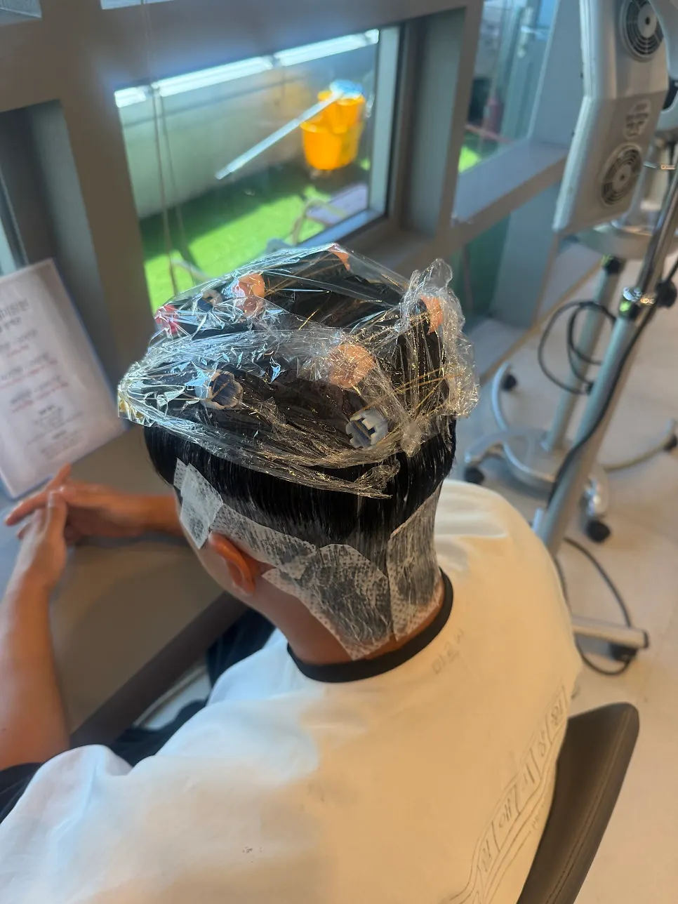 Side view of hair with perm solution applied