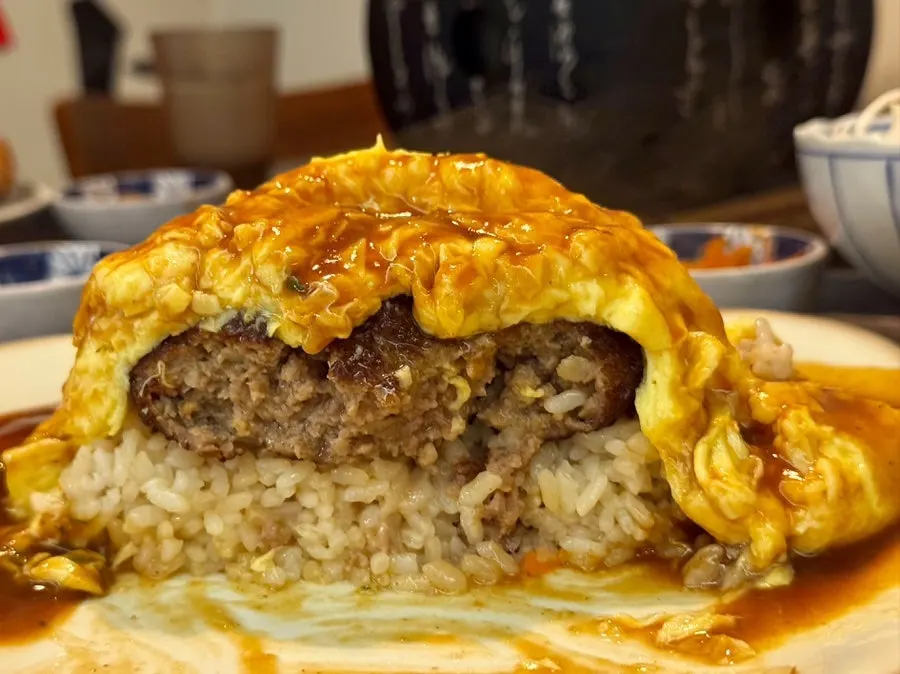 A bite of moist hamburger omurice
