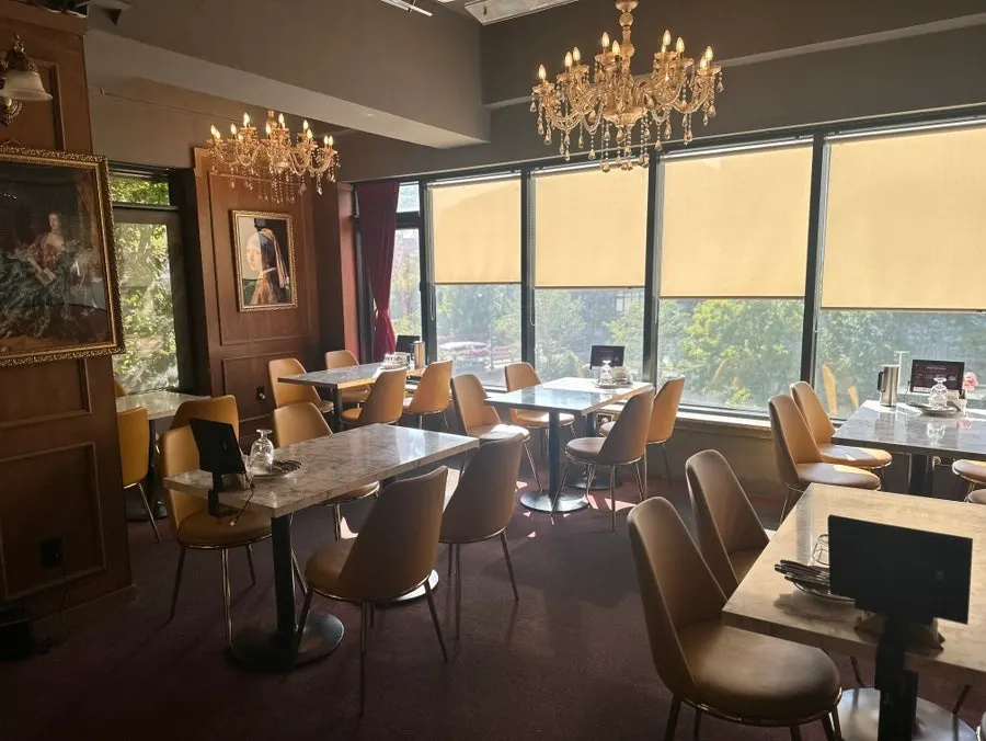 Exterior of The European Gwanggyo with sunlight through floor-to-ceiling windows
