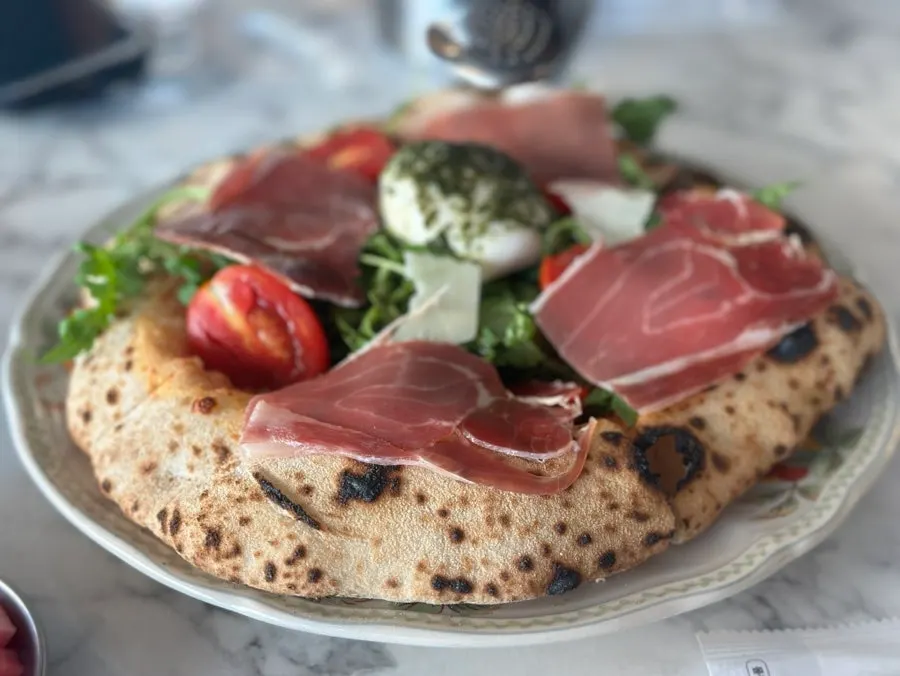 Full shot of the rocket-topped burrata hamon pizza
