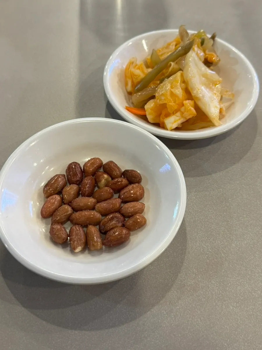 Peanuts and zhacai pickles served as side dishes