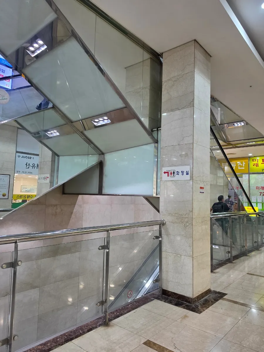 Escalator inside the building leading down to basement level 1