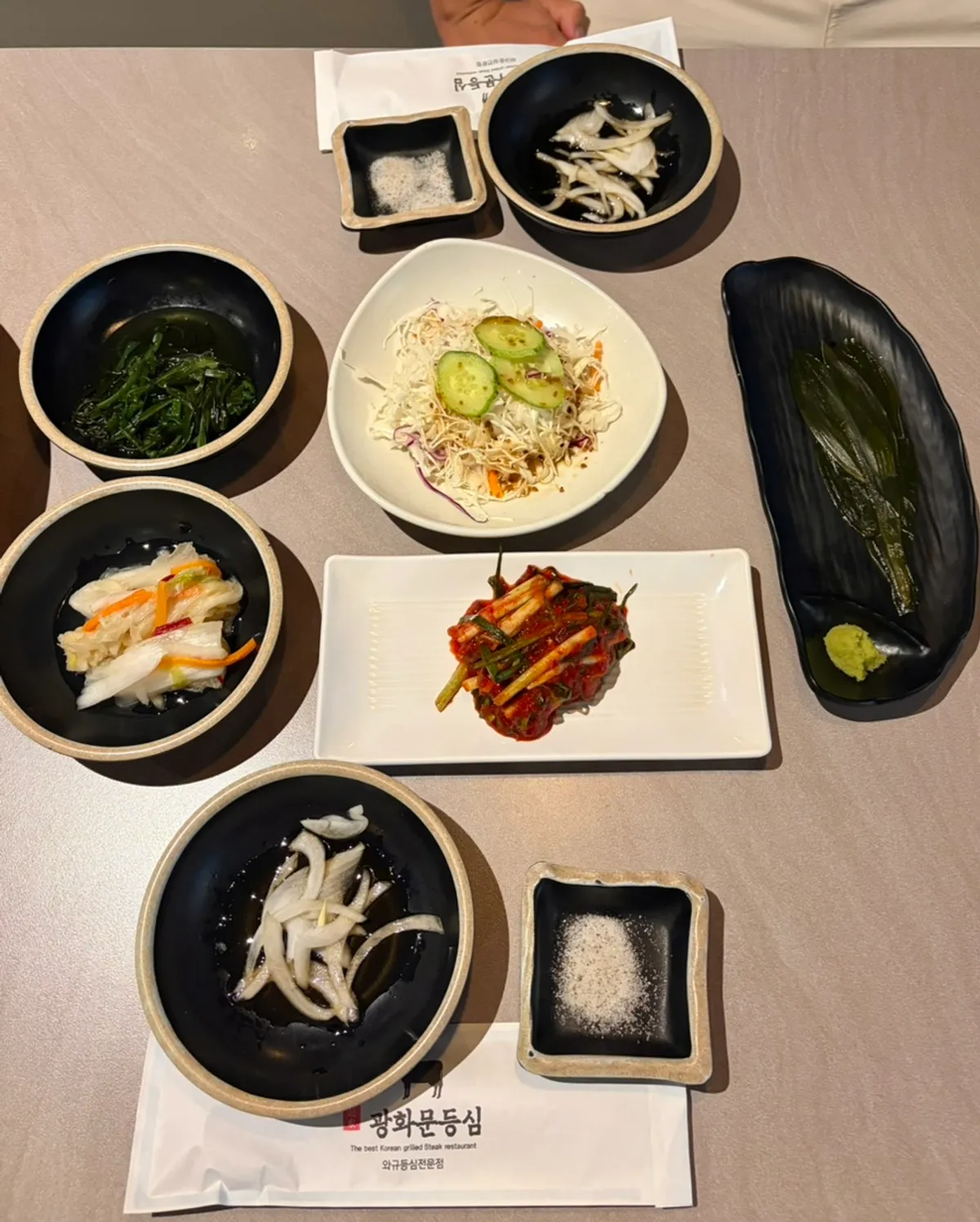 Plate of crisp scallion kimchi and other side dishes