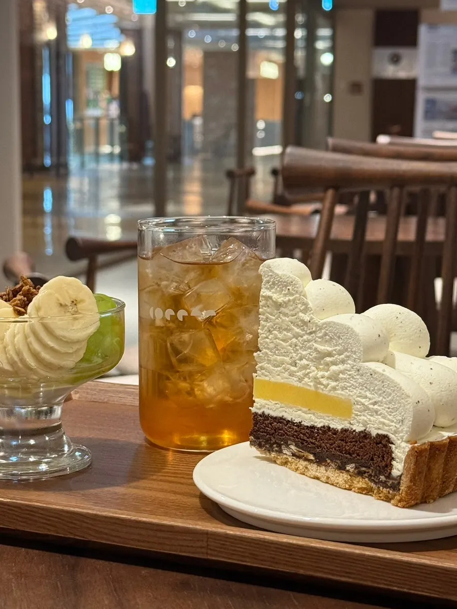 Earl Grey cake, yogurt bowl, and hibiscus tea set on the table