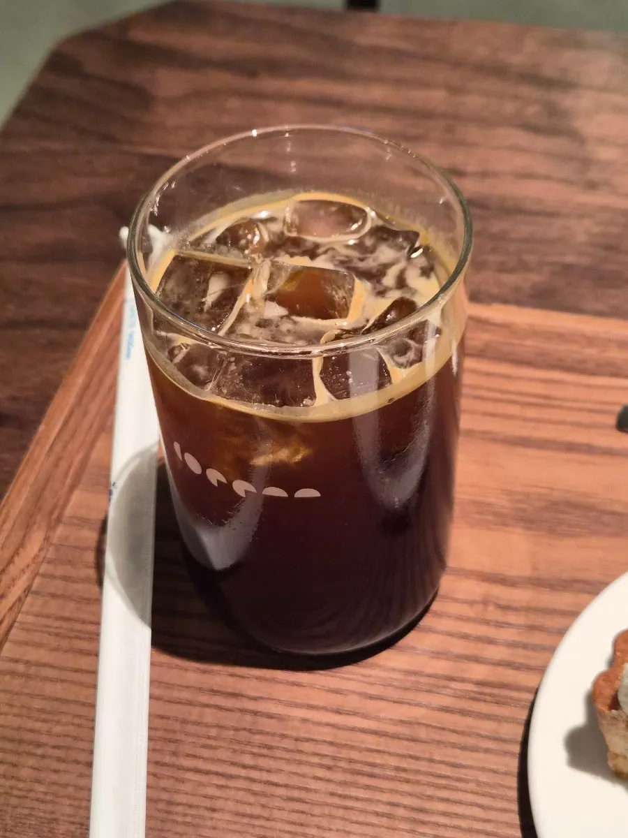 A glass of iced americano full of ice