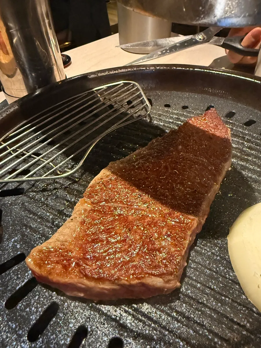 Black beef sirloin grilling on the table
