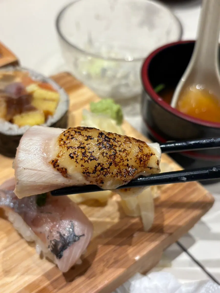 Long shrimp tempura enjoyed alongside sushi