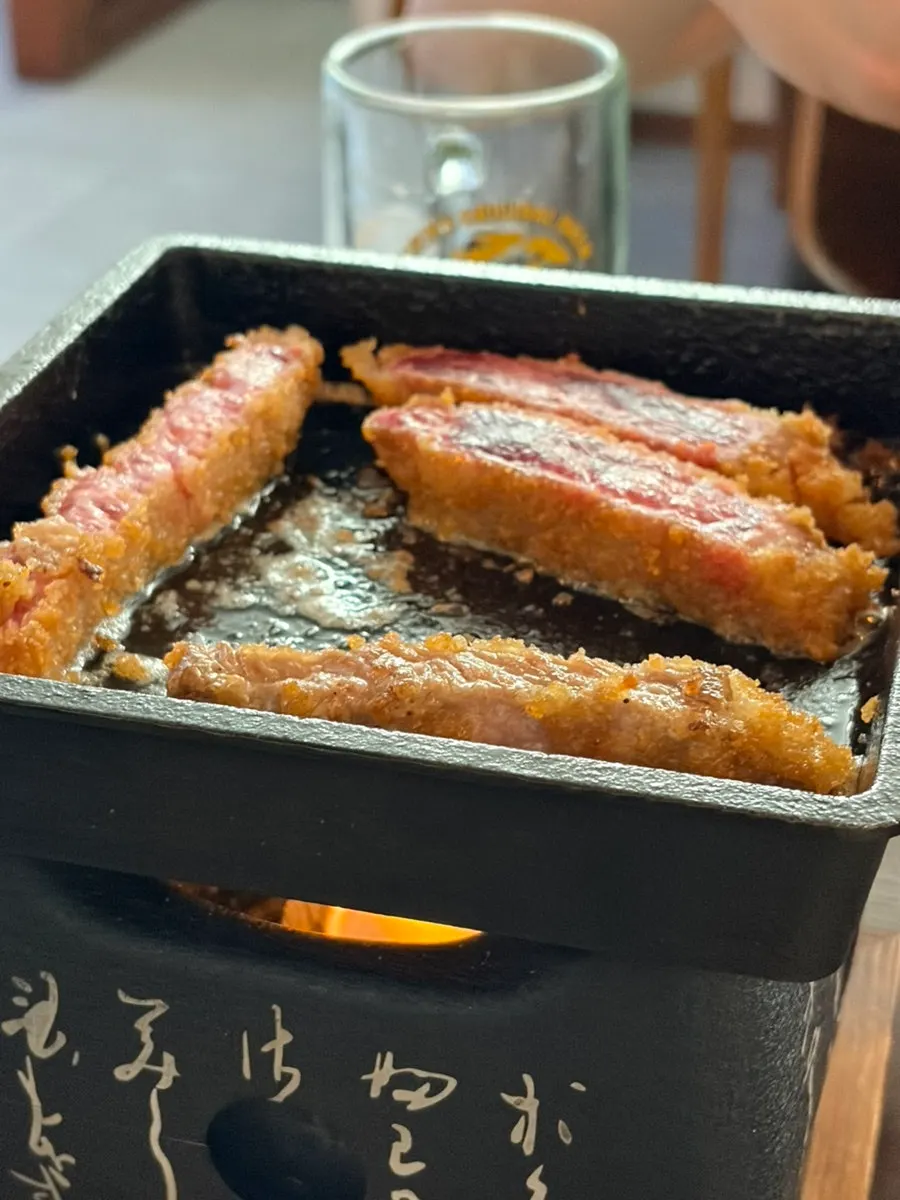 Gyukatsu on a mini brazier with melted butter