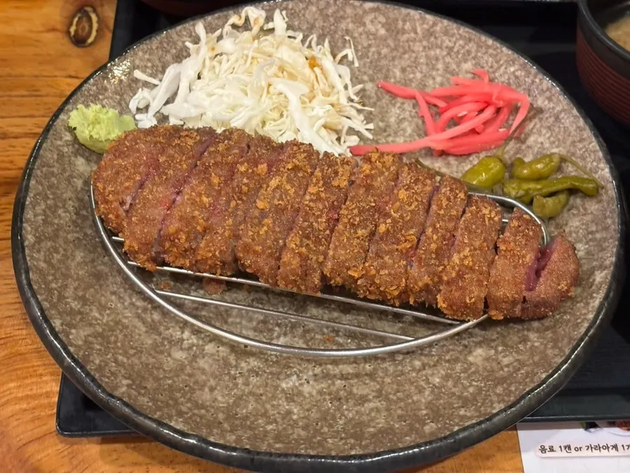 Two pieces of meat on the heated personal tabletop grill