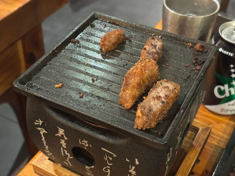 Pieces of gyusteki grilling on the tabletop grill