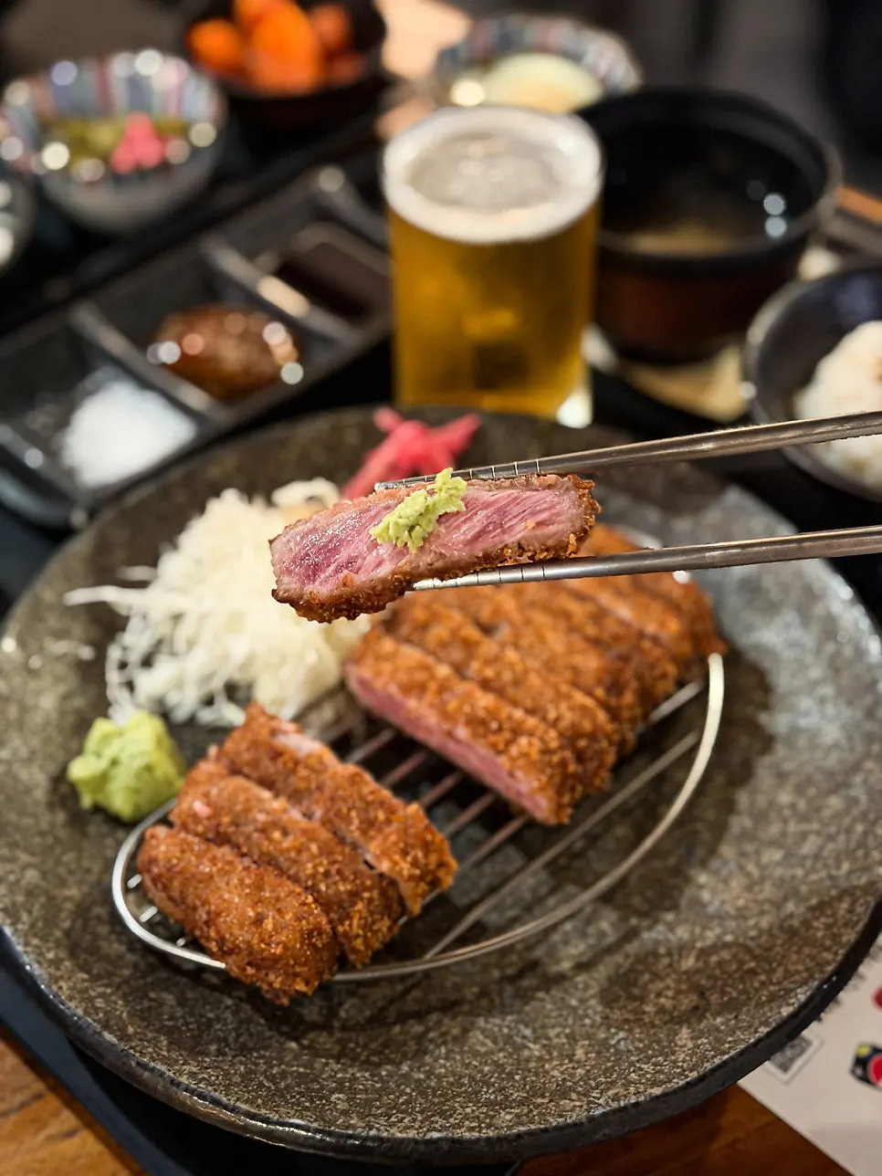 A piece of sirloin gyukatsu on the tabletop grill
