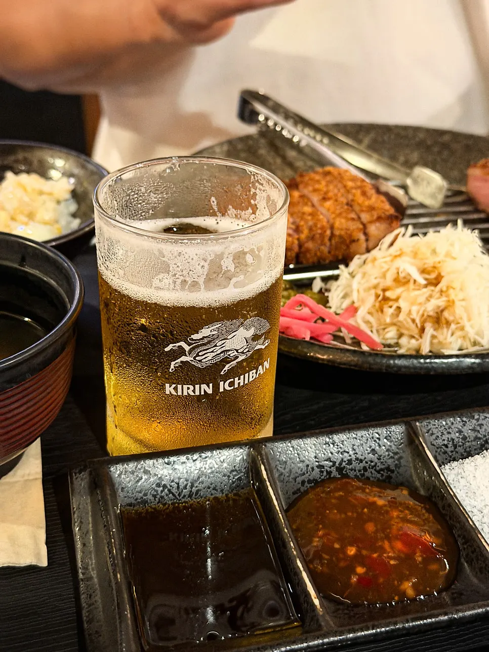Gyukatsu dipped in soy sauce and chili sauce
