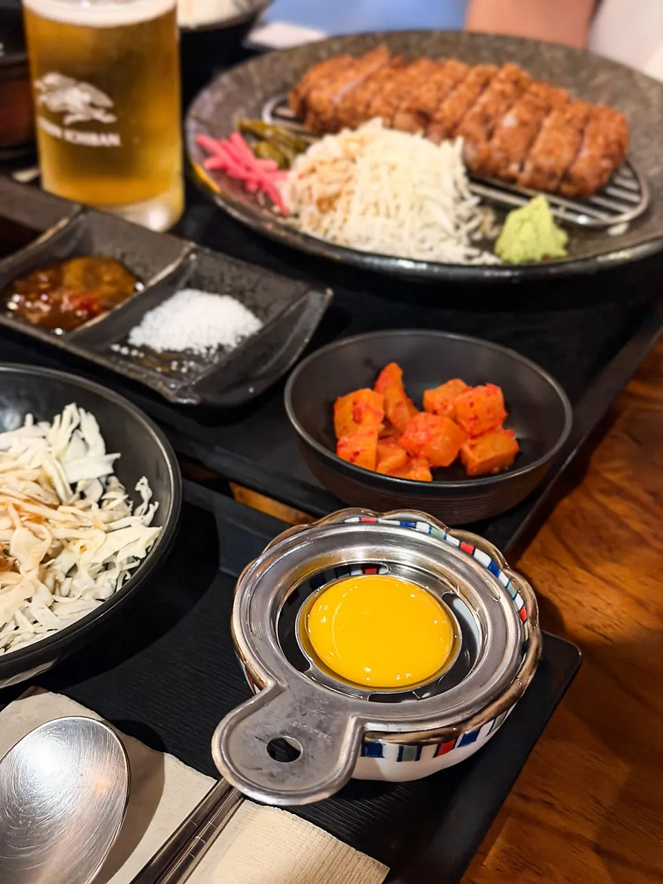 Beef belly rice bowl topped with an egg yolk