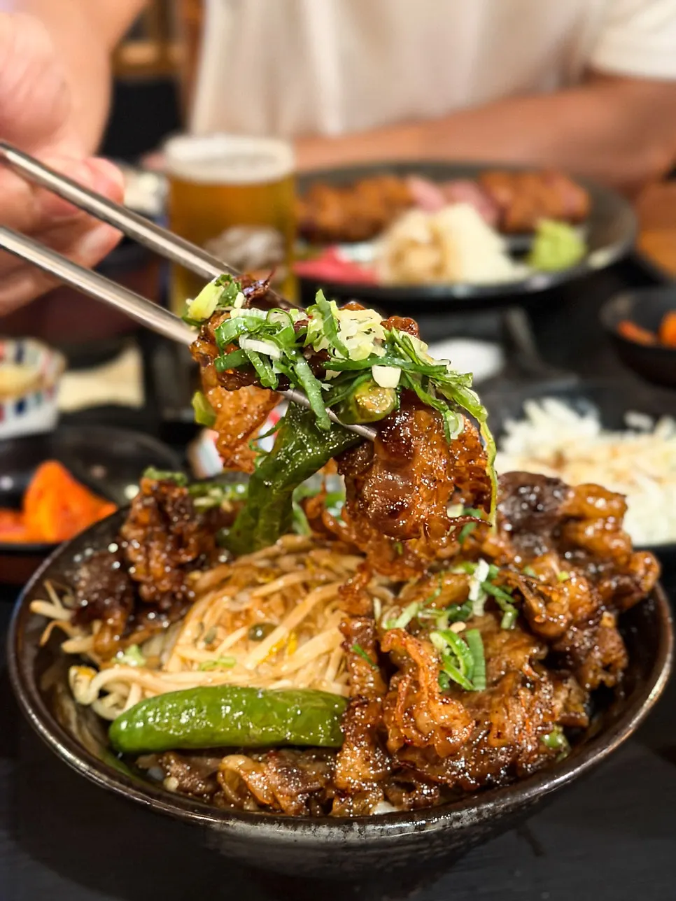 Beef belly rice bowl with green onion, bean sprouts and gochu peppers