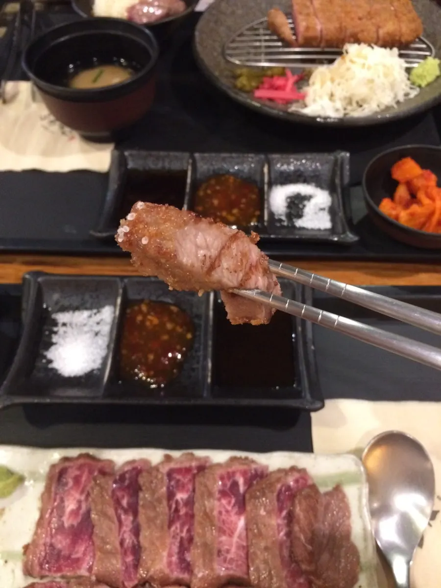 A piece of gyukatsu dipped in salt