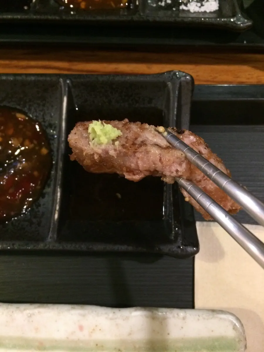 Gyukatsu topped with wasabi and dipped in soy sauce