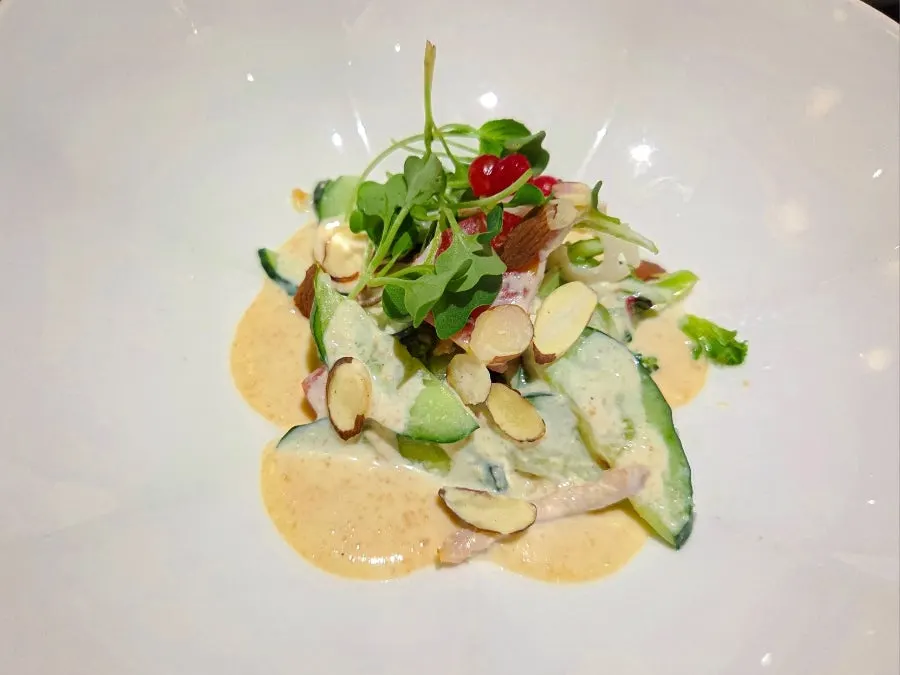 Mustard vegetables topped with pine-nut sauce and almonds