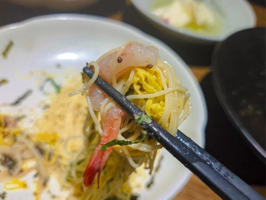 Perilla oil capellini topped with shrimp and whole perilla seeds