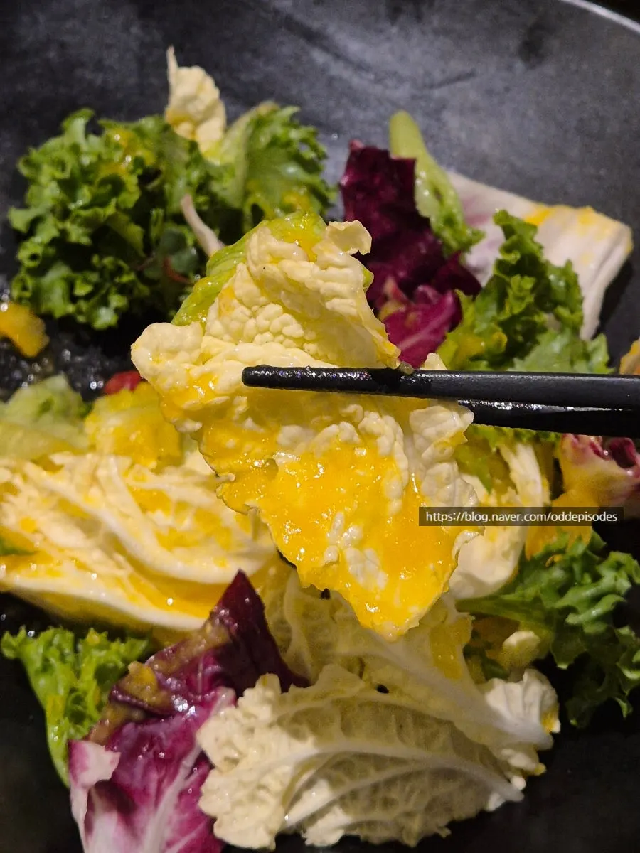 Plate of pine-nut sauce mustard-greens salad