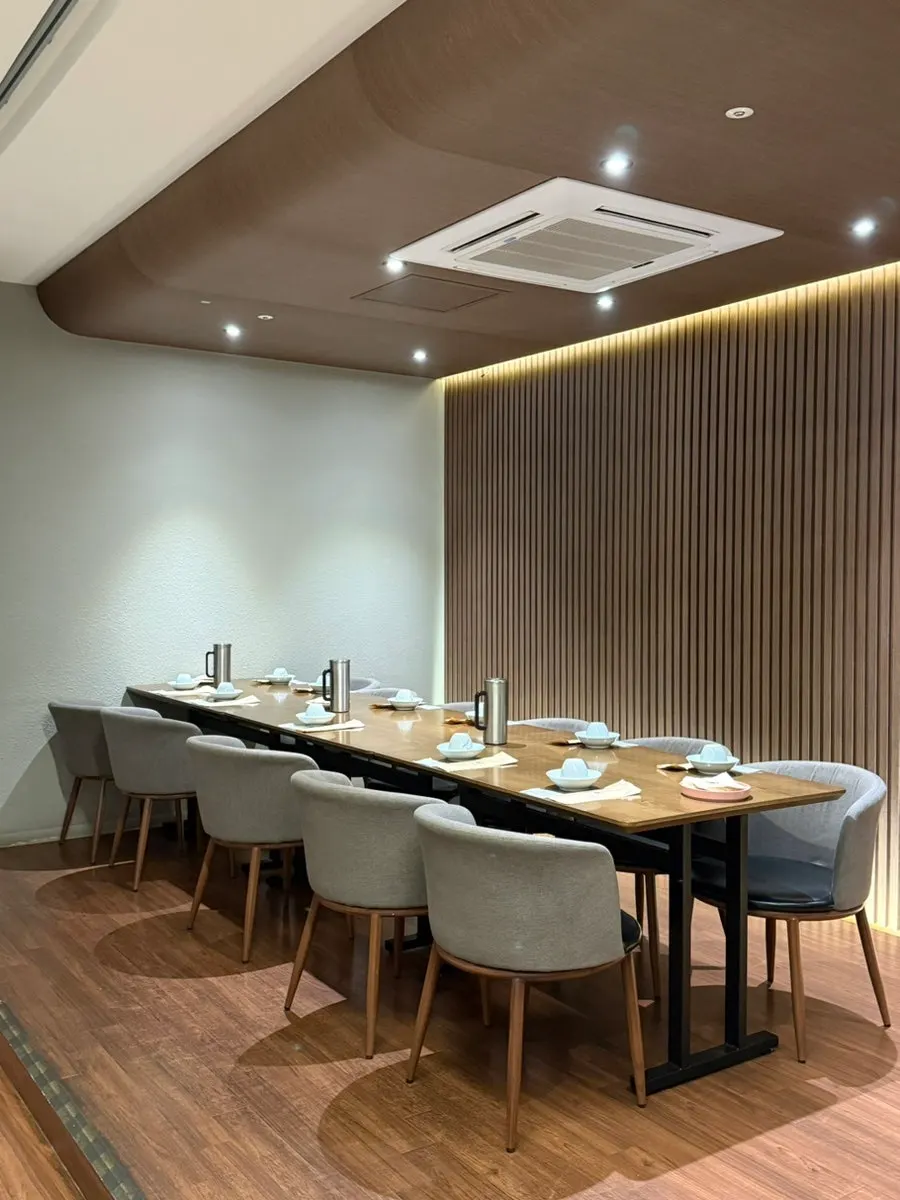 Hall table seating divided by partitions at Modam Dining