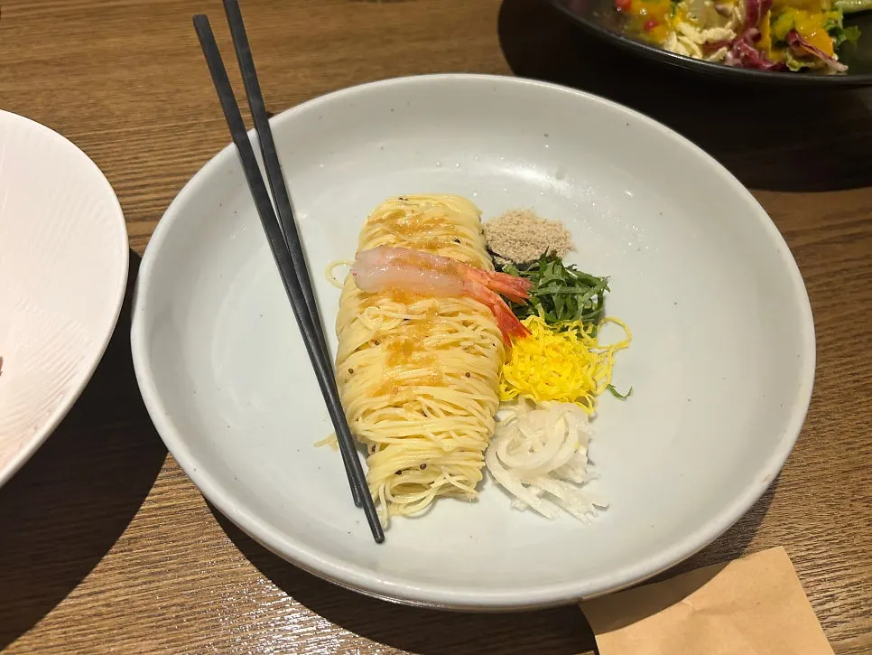 A plate of cold pasta with perilla oil and sweet shrimp