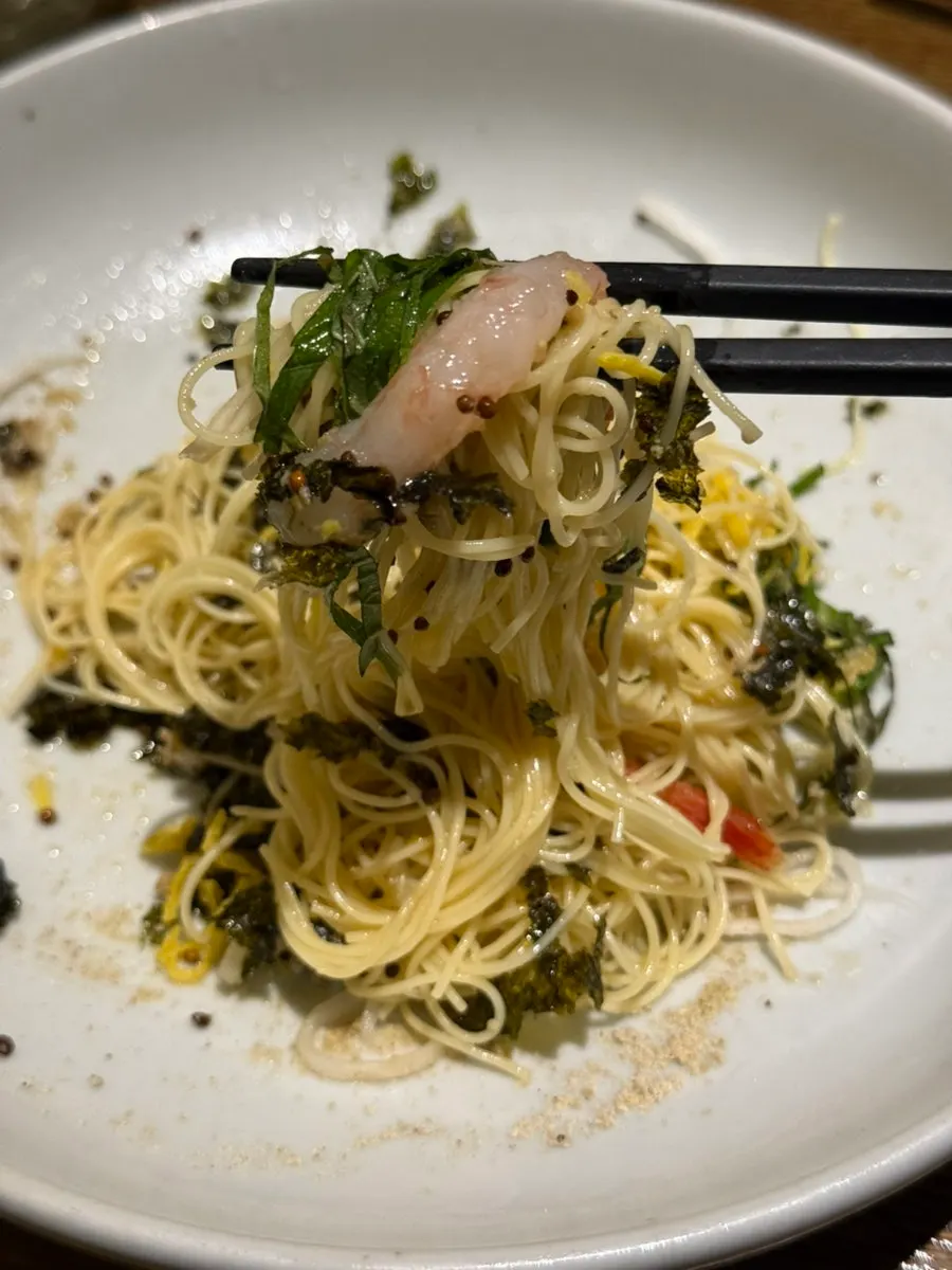 A bowl of perilla oil capellini with various garnishes