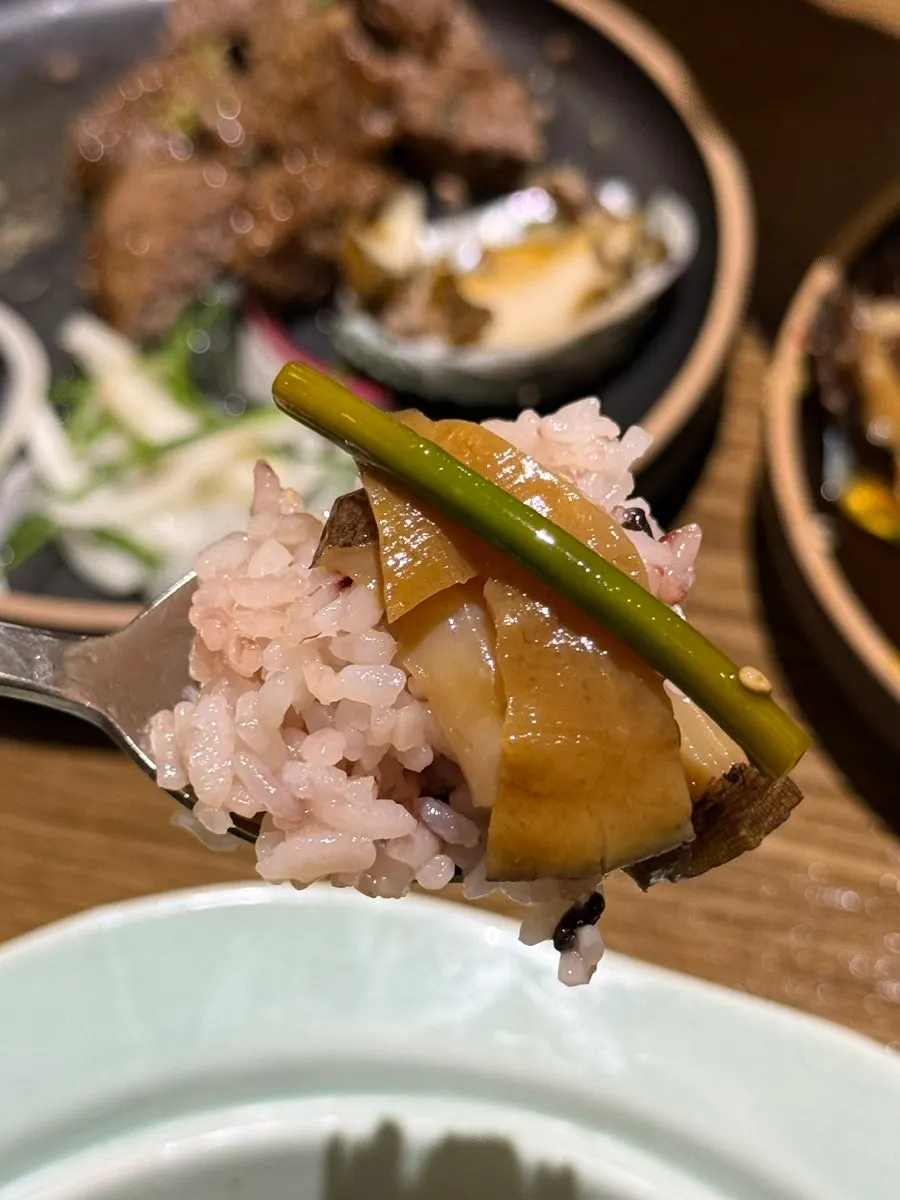 A spoonful of butter rice topped with seafood