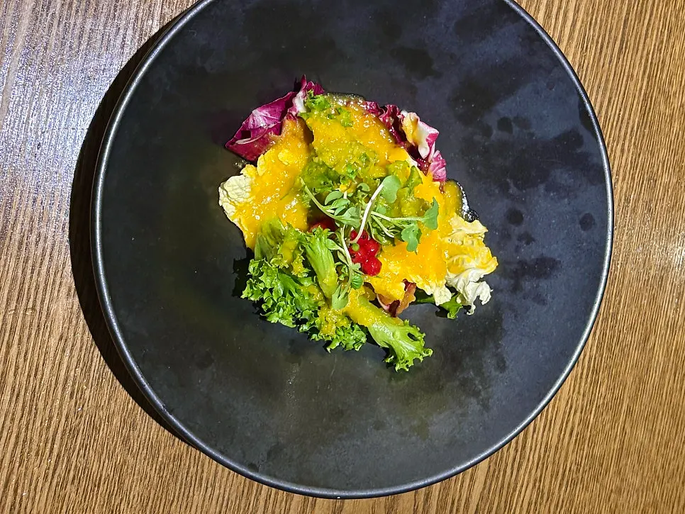 A plate of salad with dressing