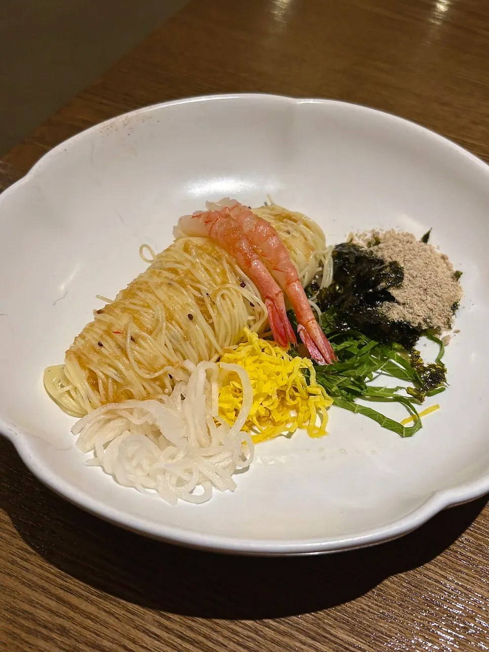 Perilla oil capellini topped with perilla powder and egg garnish
