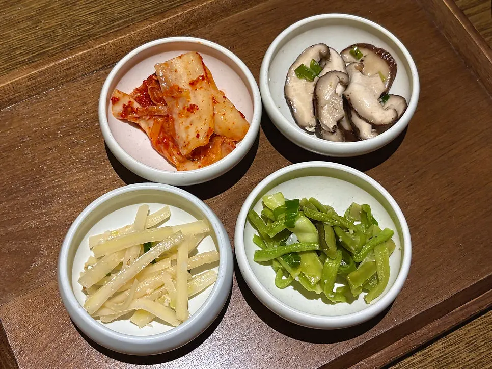 Two thick-grilled tteokgalbi patties with abalone