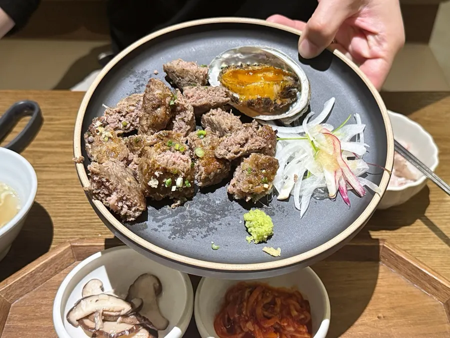 Main dish of the abalone tteokgalbi set, topped with abalone