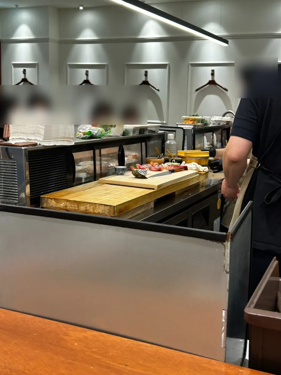 Sashimi being sliced and plated right at the bar