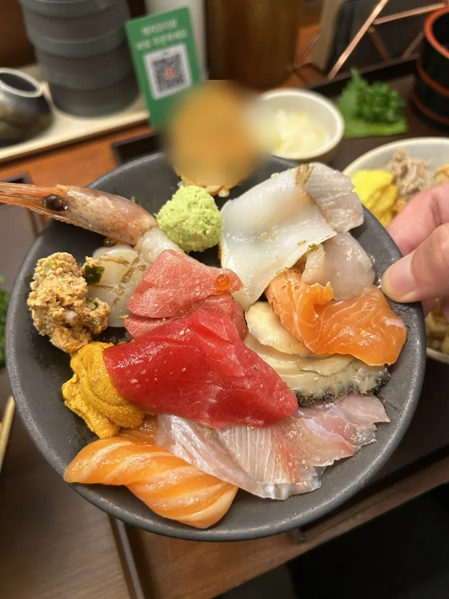 Thick sashimi slices moved onto a side plate