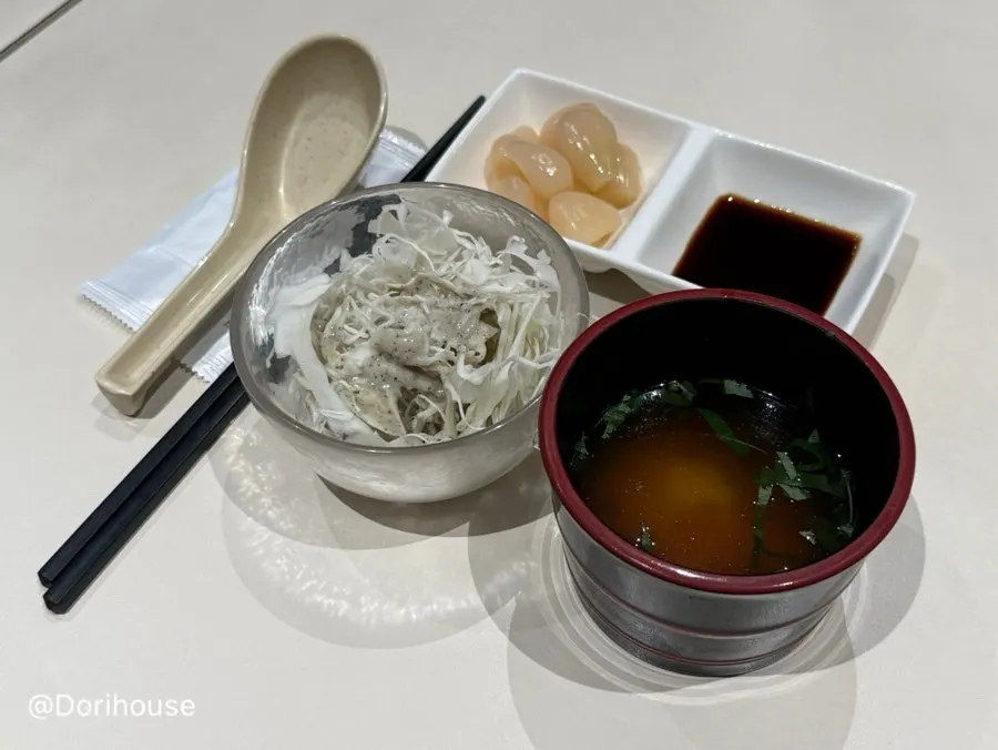 Table set with cabbage salad and clear soup