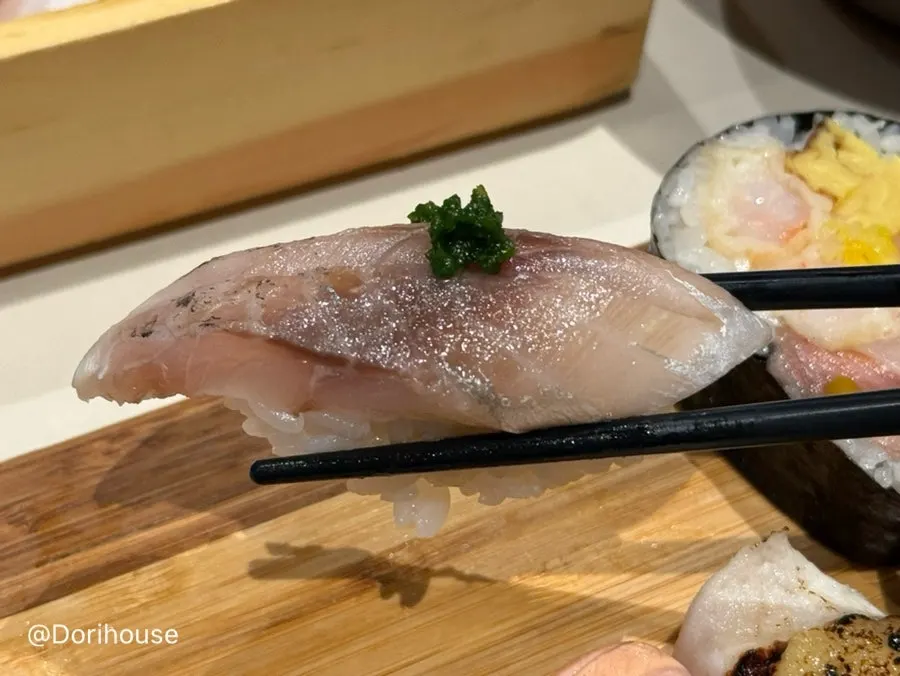 A piece of smoked amberjack sushi