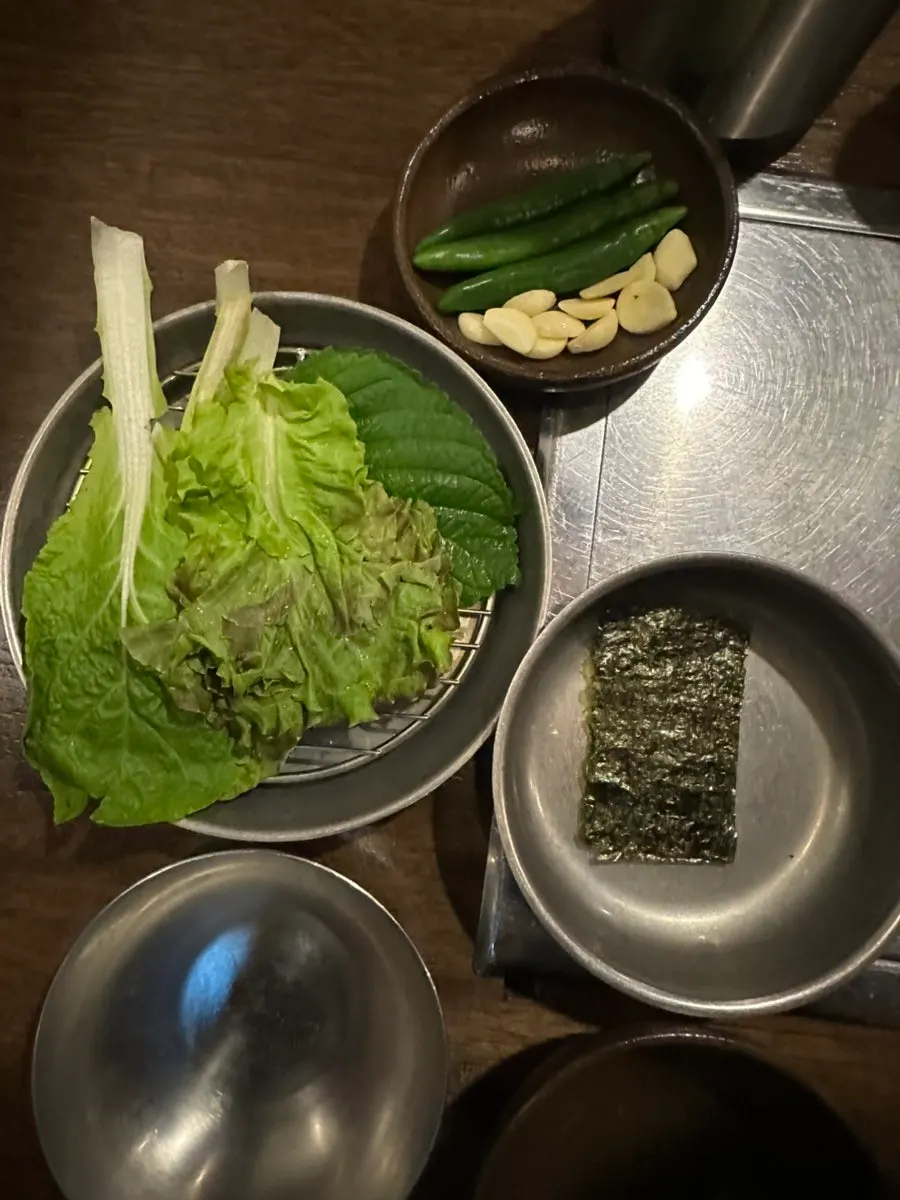 Table with doenjang soup and side dishes laid out