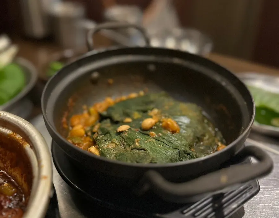 Plate of tofu doenjang stew with squash leaves and tofu