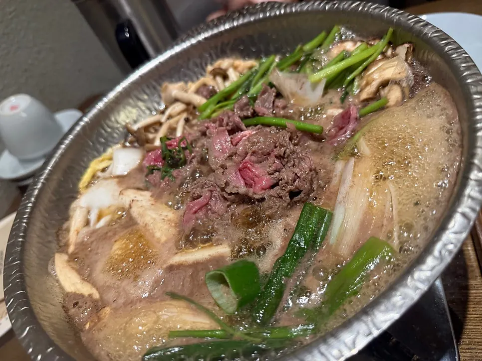 Bulgogi hot pot served with rice and side dishes