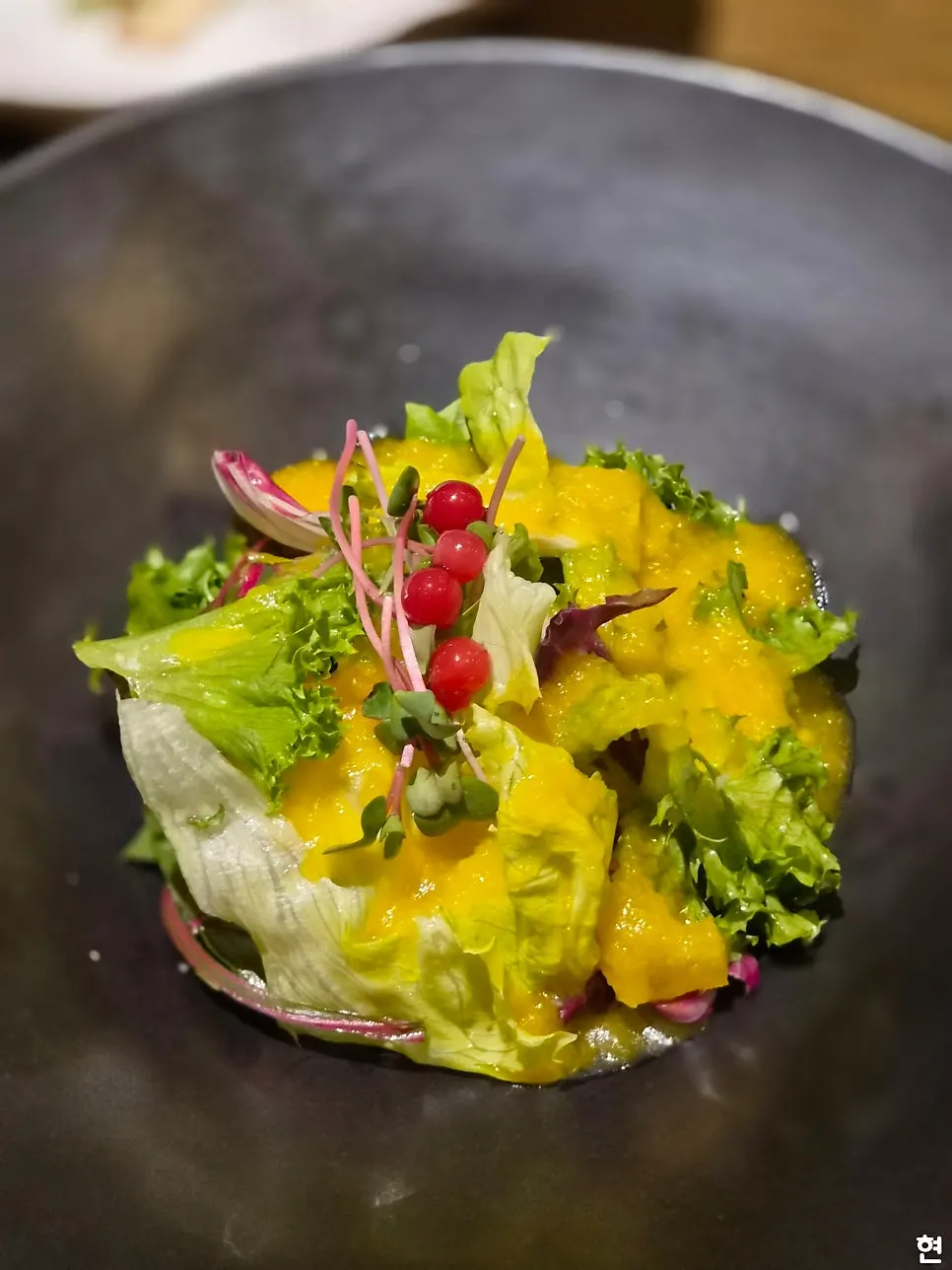 Early course plates on the table at Modam Dining