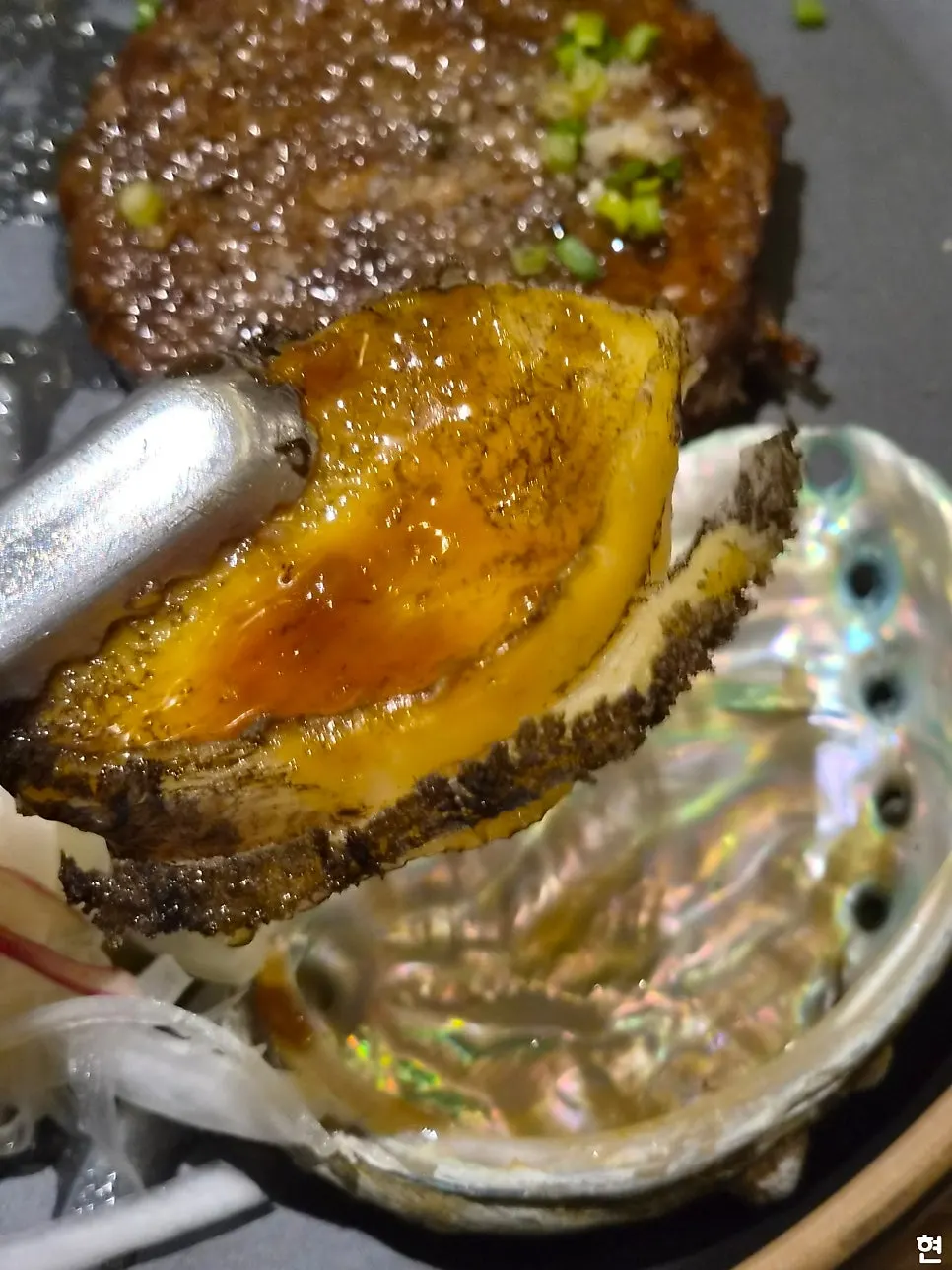 Abalone from the tteokgalbi set cut with scissors
