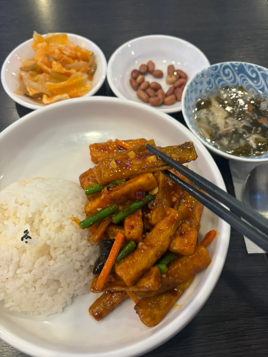 A spoonful of the eggplant tempura rice bowl