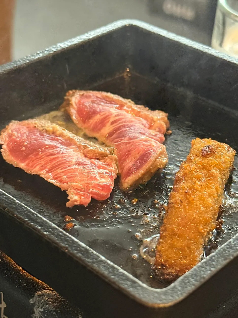 Grilling meat on the tabletop brazier