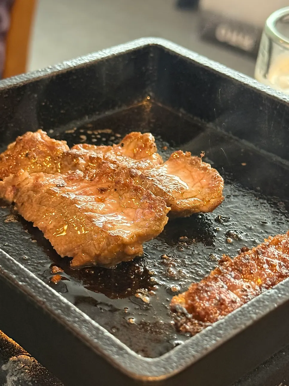 Meat cooking on the tabletop brazier